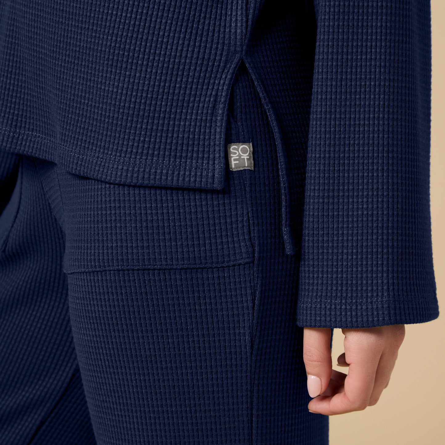 Detail of Softies AirThermal Henley Lounge Set in Midnight showing side slit and front patch pocket